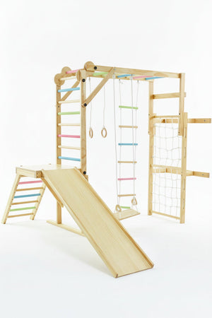 A wooden indoor jungle gym playset features colorful bars, a slide, climbing ropes, and rings, designed for childrens play. Its eco-friendly construction provides a safe, engaging environment for active play.