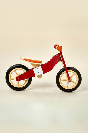A red and wooden 2-in-1 balance bike with a sleek design features two wheels and a comfortable seat, designed for toddlers aged 2 to 4 years for safe riding.
