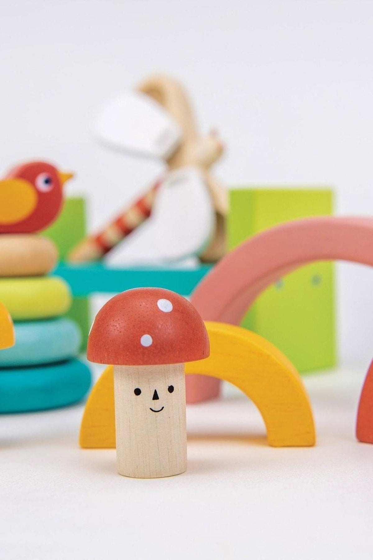 Colorful wooden toy set featuring a smiling mushroom, arches, and a bird, ideal for toddlers playtime.
