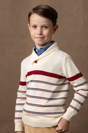 A boy models a cream shawl collar sweater featuring red and navy stripes, paired with a blue button-up shirt.