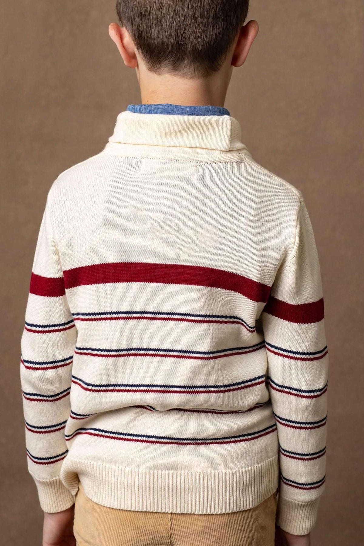 A boys ivory striped sweater features a shawl collar and is made of soft organic cotton, perfect for casual wear.