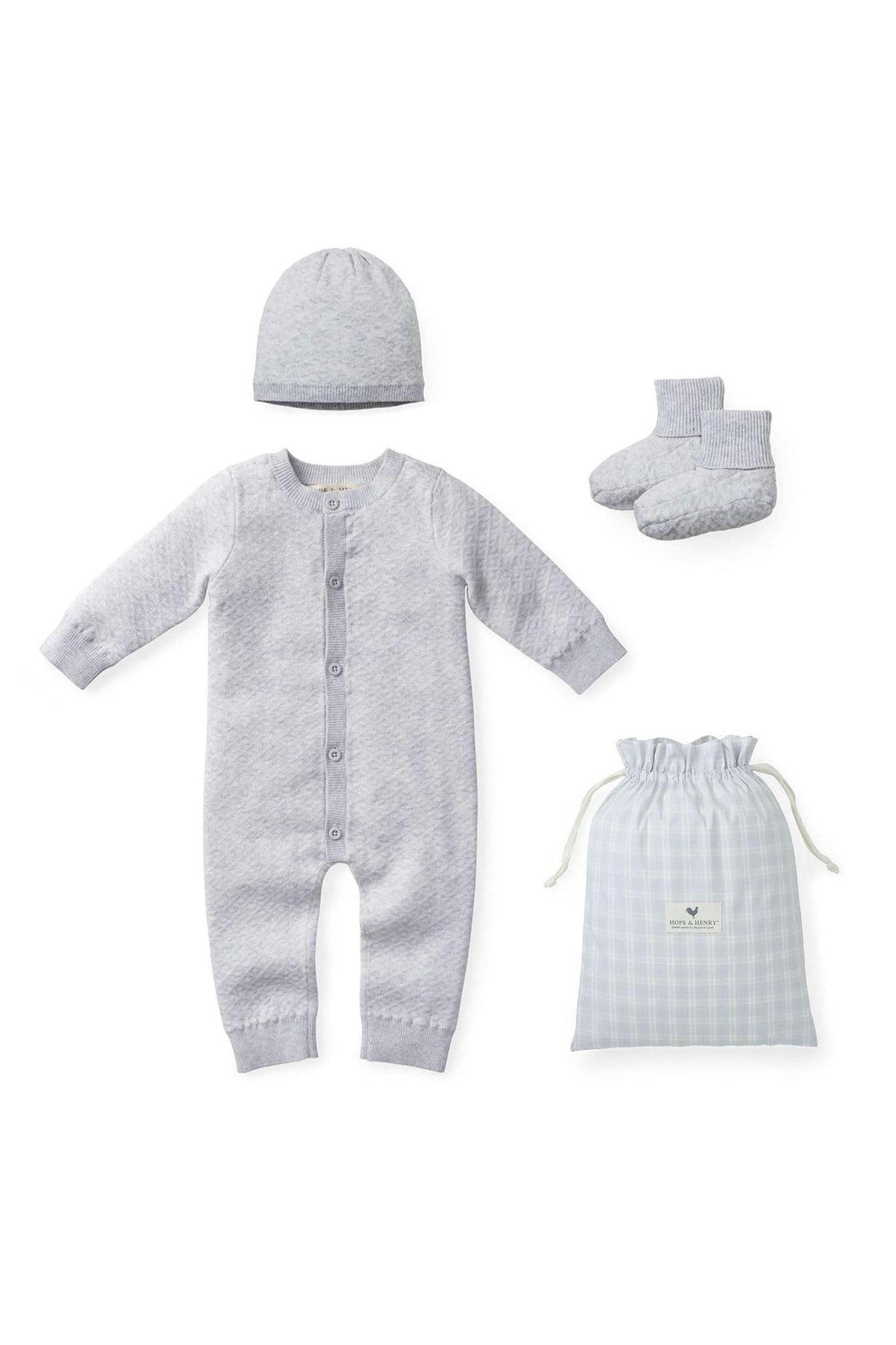 Light gray jacquard knit romper set from Hope & Henry, featuring a matching beanie and booties, all made from soft organic cotton. Comes in a stylish plaid gift bag.