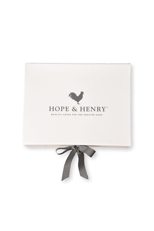 A neatly tied gray ribbon adorns a white gift box featuring the Hope & Henry logo, which reads Quality Goods for the Greater Good. The box is elegant and inviting.