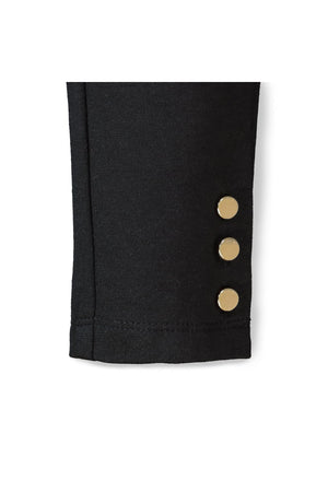Close-up of a black ponte pant cuff featuring three gold button accents. Made from organic cotton, this stylish piece is ideal for toddlers and girls seeking comfort and elegance.