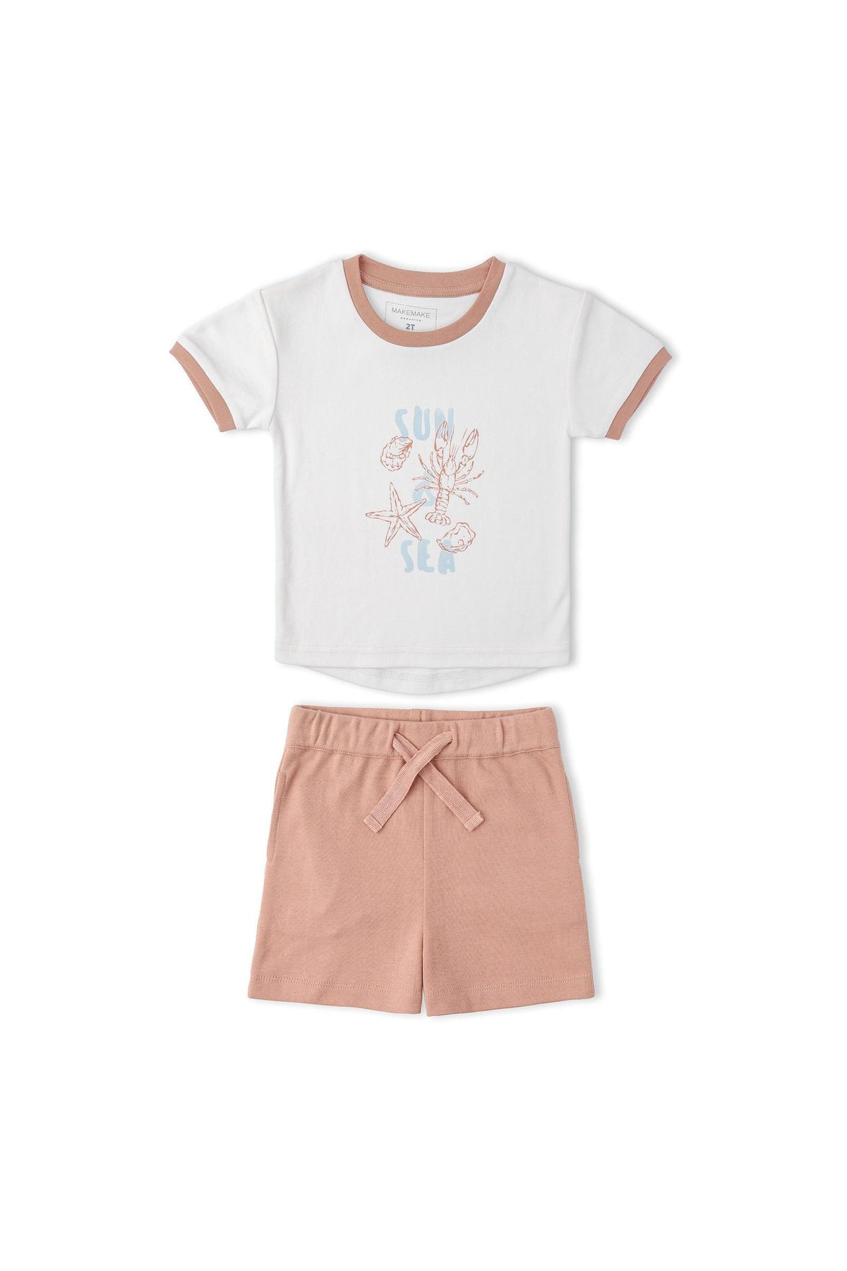 A soft white graphic tee with a Sun print and pink trim is paired with matching pink shorts. The set is made from organic cotton, perfect for comfortable summer wear.