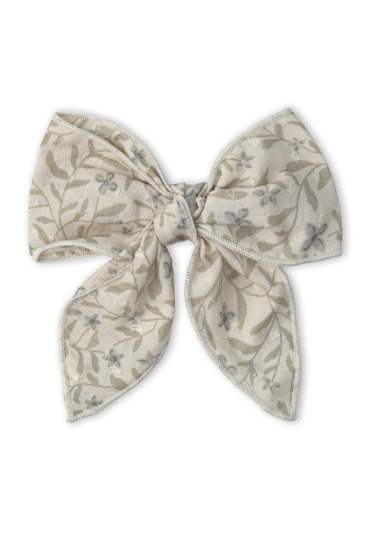 A large hair bow clip made from soft, organic cotton features a delicate floral pattern in muted colors.