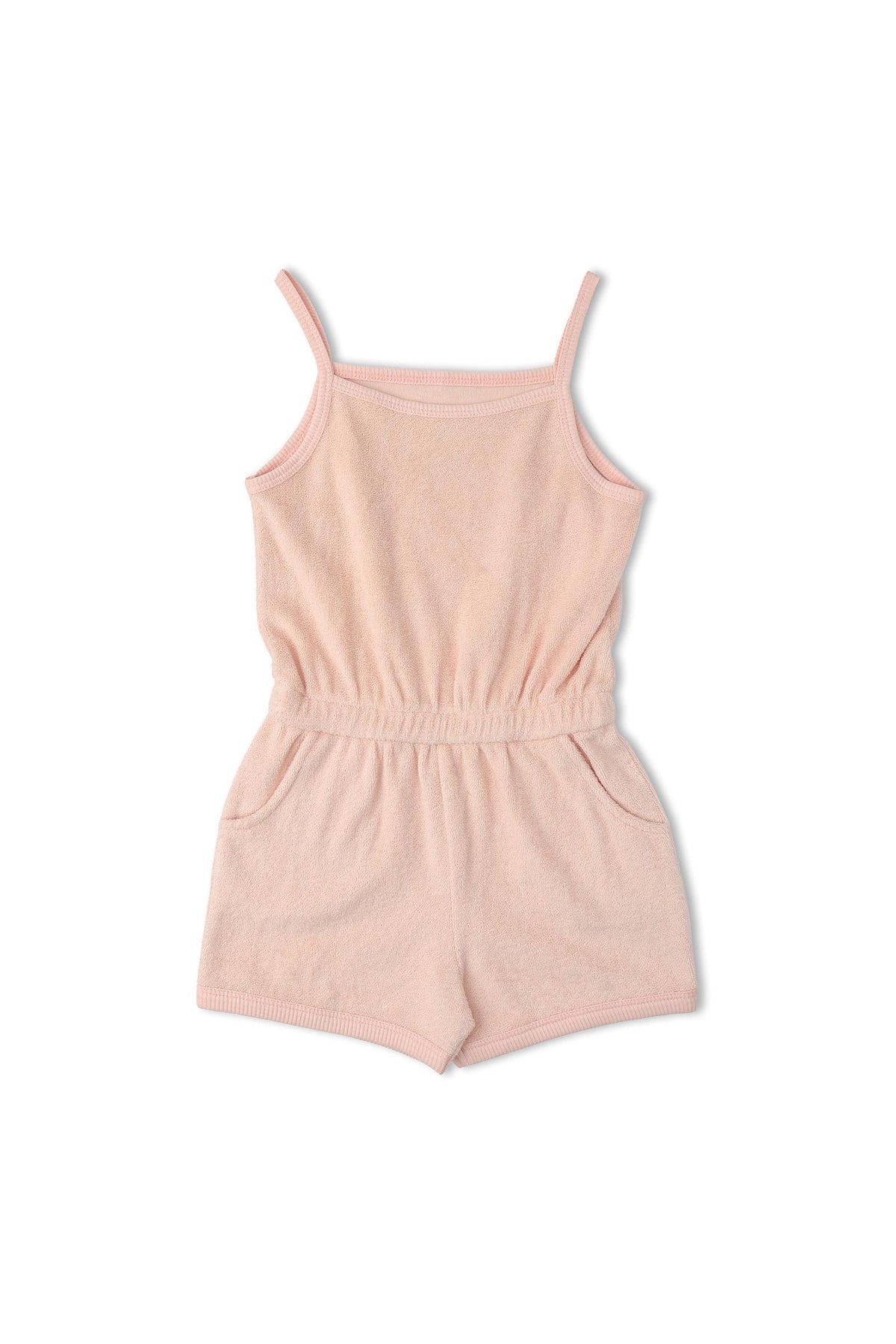 A soft blush organic tank romper features adjustable straps and side pockets, made from breathable terry fabric. Ideal for warm-weather activities, this stylish piece is perfect for kids.