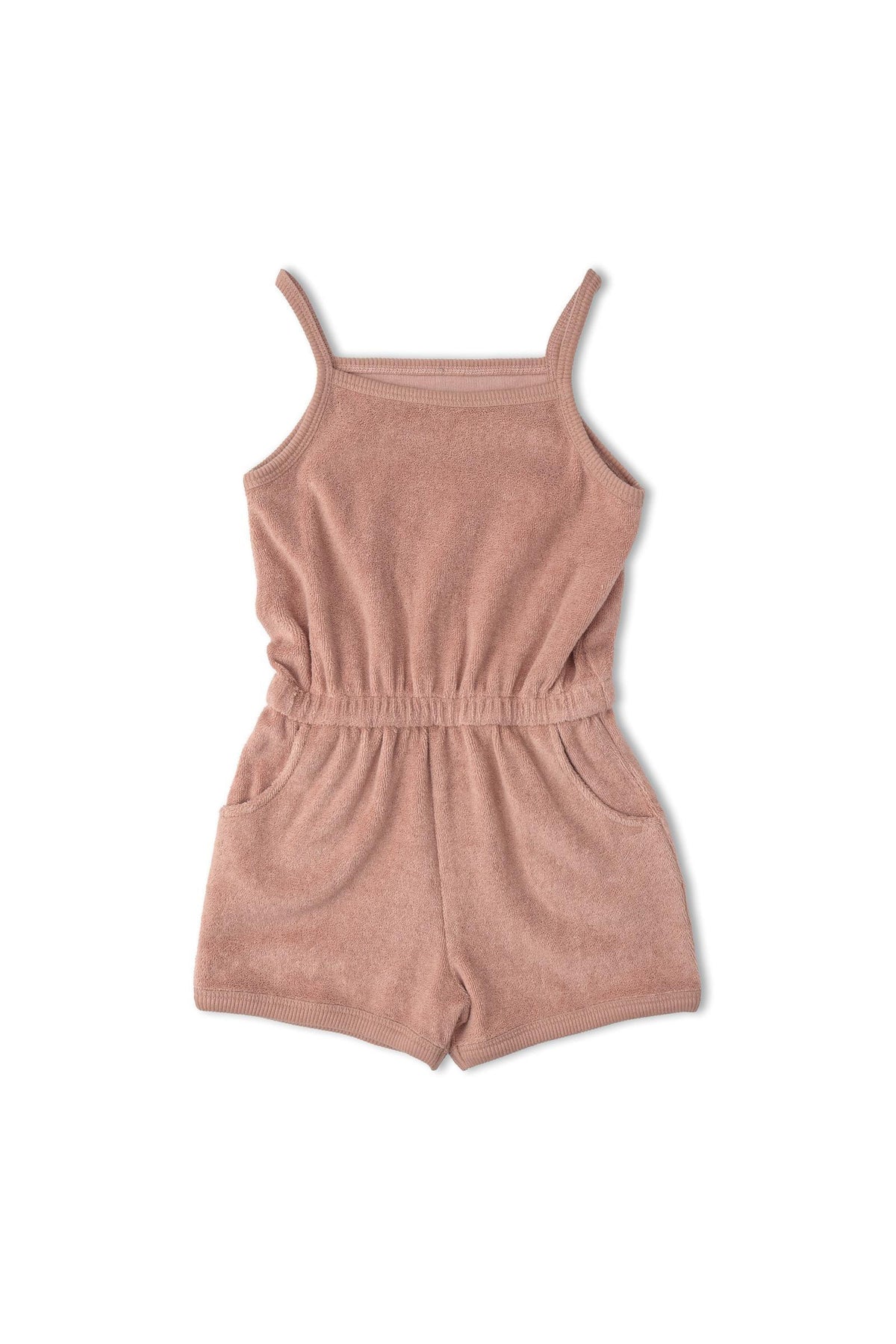 A clay-colored organic tank romper made from soft terry fabric features thin straps and an elastic waistband with pockets. Ideal for warm-weather outings, this sustainable piece is designed for comfort.