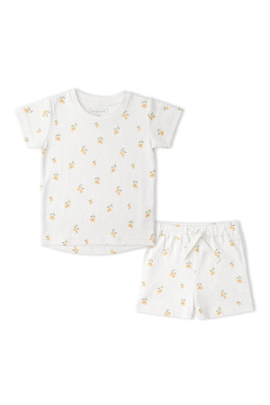 Organic cotton tee and shorts set featuring a playful lemon print on a white background. Ideal for warm days, this sustainable outfit is perfect for childrens playtime.