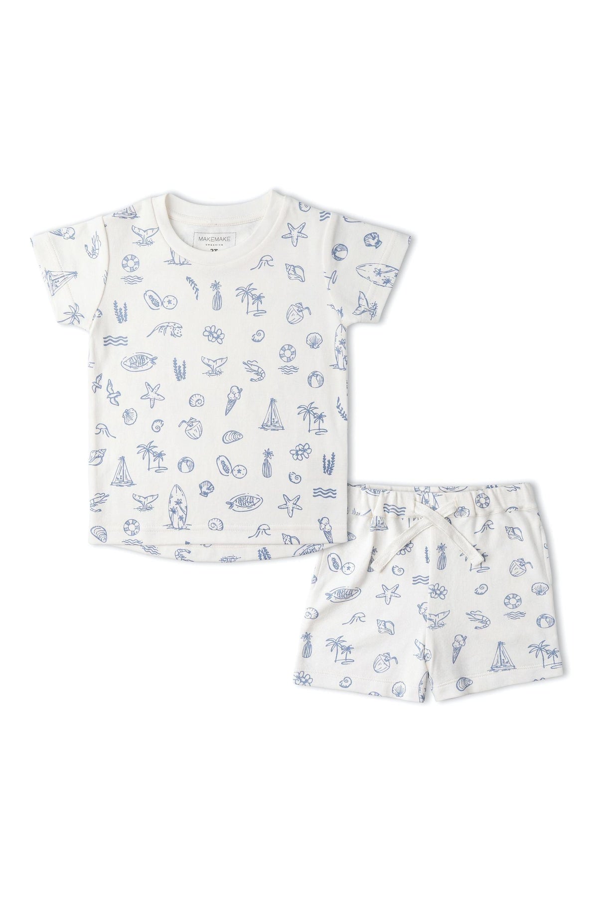 A coastal-themed organic cotton tee and shorts set features playful blue illustrations of seashells, palm trees, and surfboards on a light background. Ideal for summer outings and comfortable play.