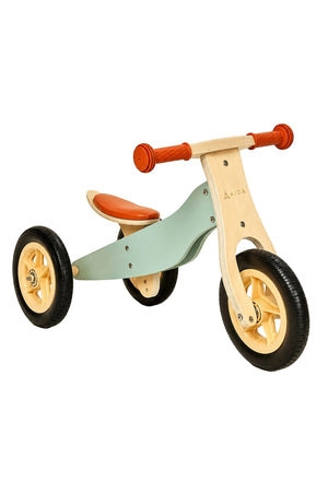 A wooden balance bike in mint green and natural wood features a comfortable orange seat and sturdy rubber wheels.