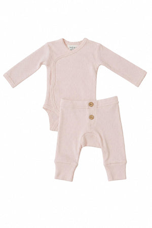 A pink pointelle layette set for baby girls, featuring a long-sleeve bodysuit with a wrap design and matching pants with decorative wooden buttons. Crafted from soft, breathable cotton for comfort.