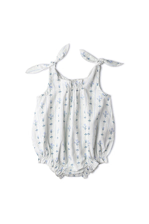 Organic cotton bubble romper featuring a blue vines print, adjustable tie shoulder straps, and a relaxed silhouette. Designed for comfort and playful style for young children.