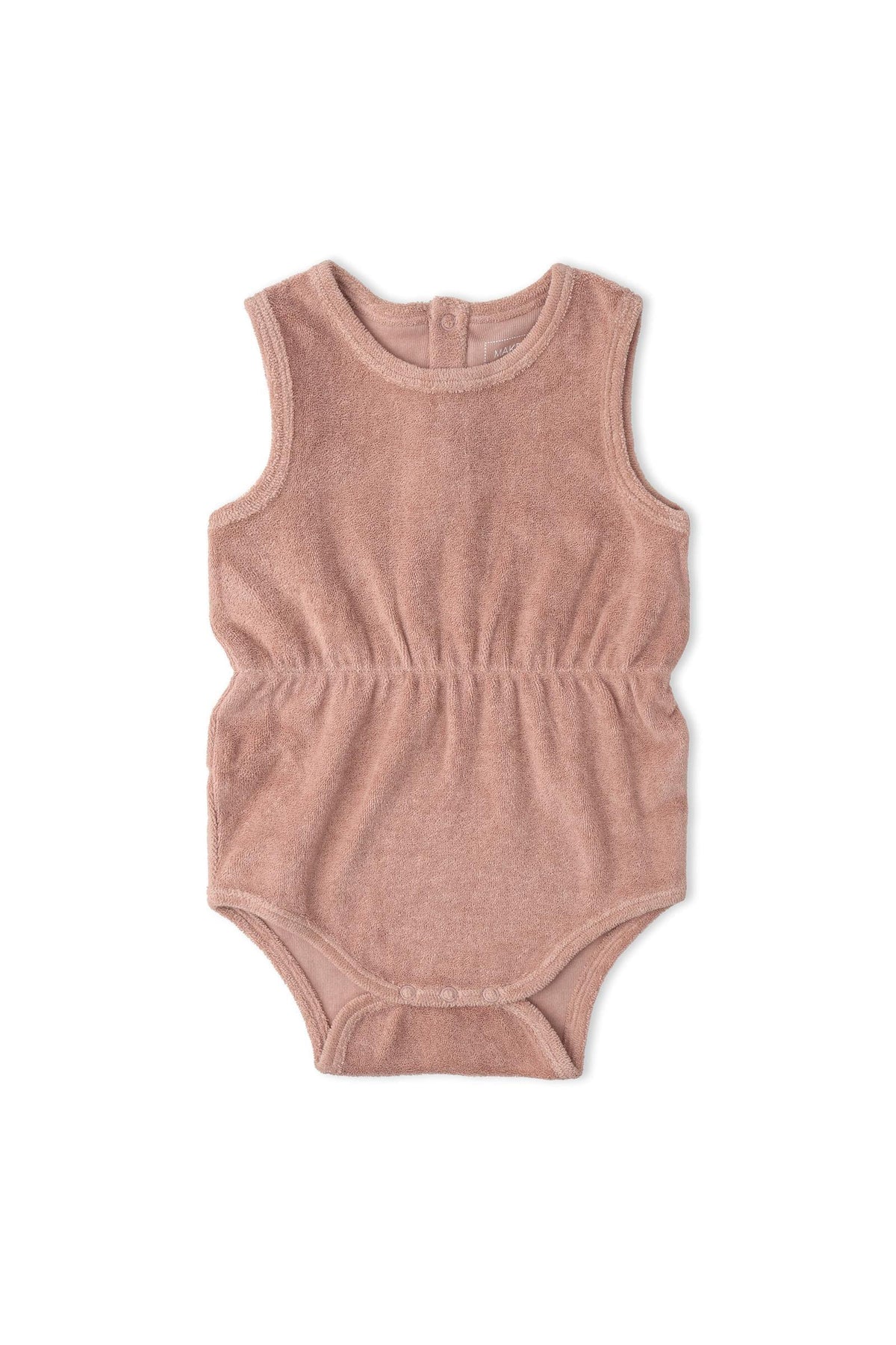 A soft clay-colored romper made from organic cotton features a gently gathered waist, ideal for warm-weather wear. This lightweight piece is perfect for sunny day adventures for little ones.