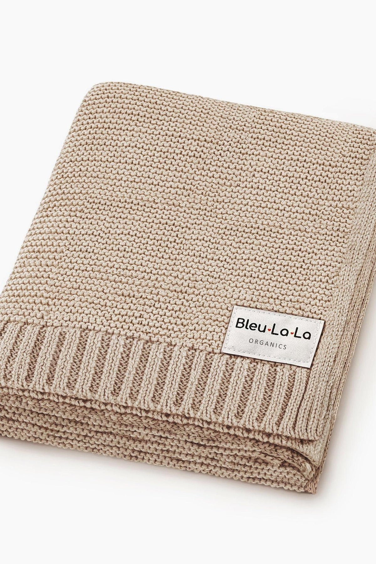 Beige knit blanket with a ribbed edge and a Bleu La La Organics label, folded neatly.