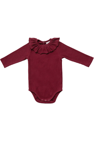 Burgundy ribbed cotton bodysuit featuring a ruffled collar and long sleeves, designed for baby girls. Ideal for everyday wear and made from soft, sustainable materials for comfort and flexibility.