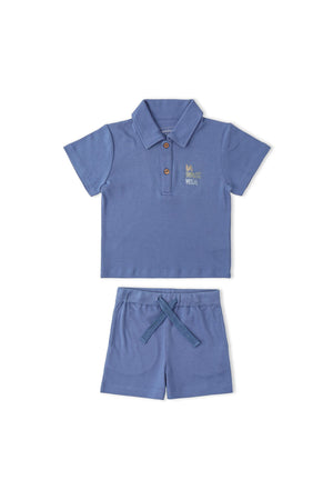A slate blue organic cotton polo shirt with a collar and three buttons is paired with matching shorts featuring a drawstring waist. This playful set is perfect for children.
