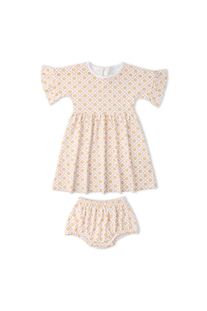 A light yellow floral dress with short dolman sleeves and a playful gathered skirt, paired with matching bloomers. Made from soft organic cotton, it’s perfect for everyday comfort.
