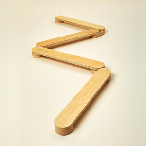 Aida Kids Little Equilibrist Balance Beam features a zigzag design made of smooth, sustainable wood, providing an engaging and safe play surface for children to enhance their coordination and balance.
