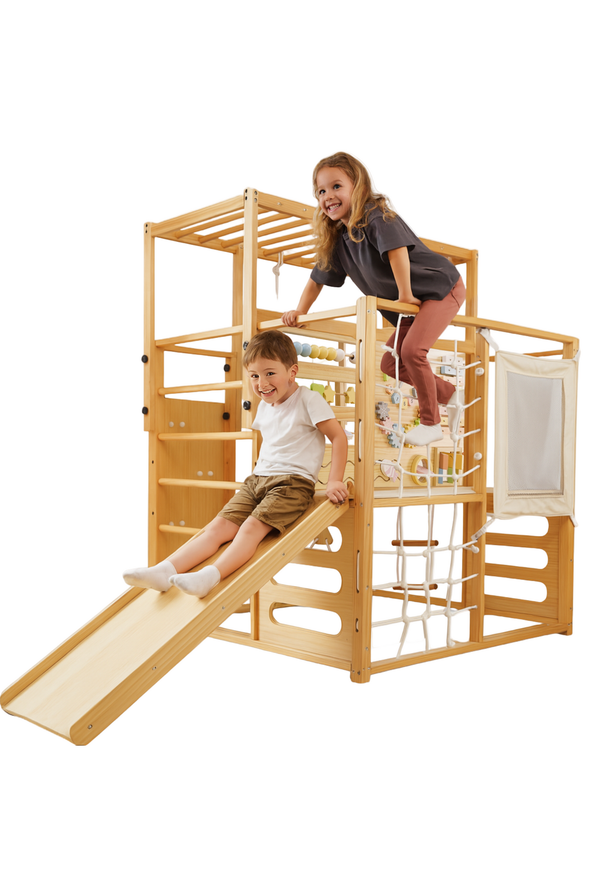 A boy slides down a wooden slide while a girl climbs on top of a multi-level play gym.
