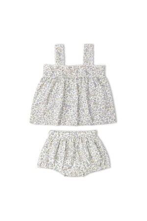 A floral-patterned, sleeveless top with a gathered waist is paired with matching bloomers. The set features soft, breathable fabric, ideal for warm weather, and is suitable for young children.