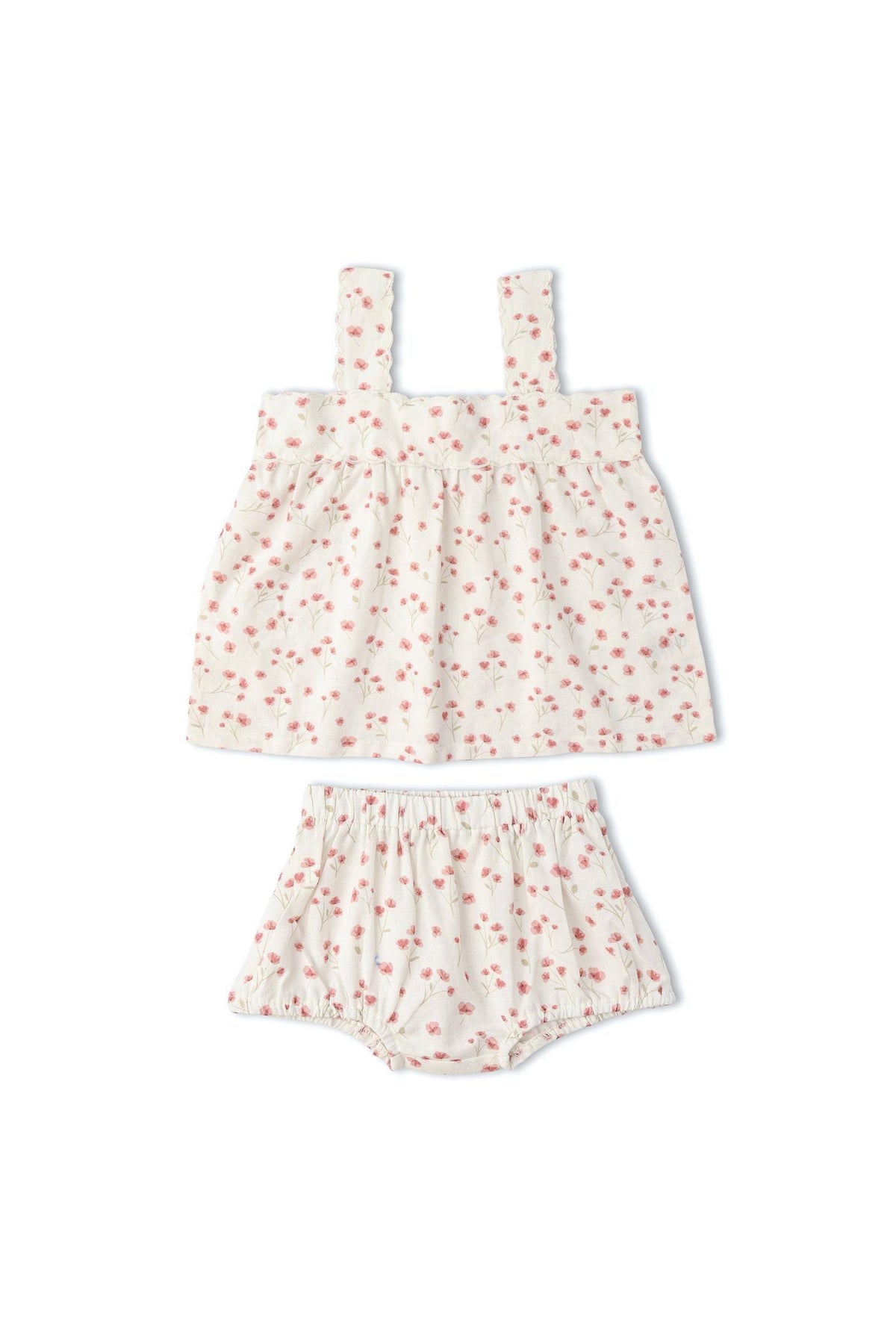 A soft, organic cotton scalloped top and matching bloomers set features a delicate floral print on a light background. This charming outfit is perfect for warm-weather days and young children.