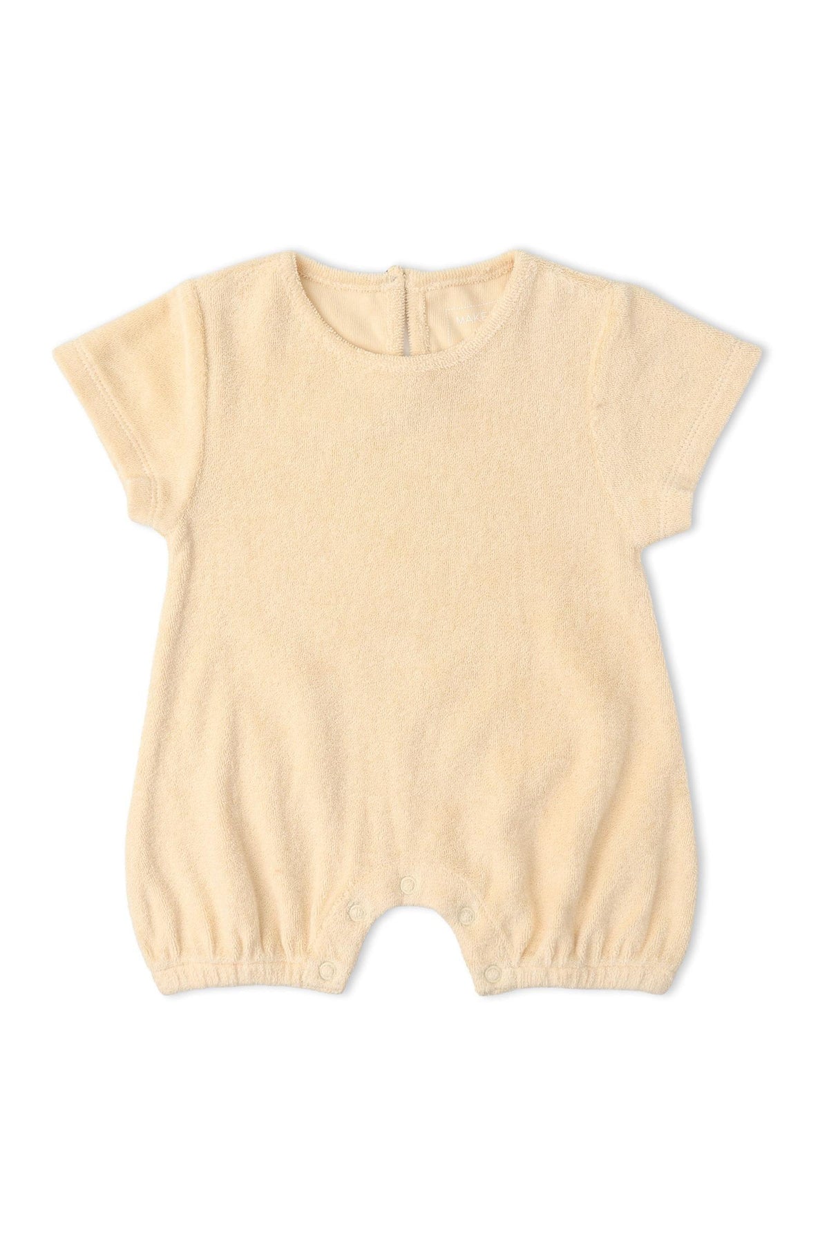 Butter yellow organic cotton short romper featuring a relaxed silhouette and soft texture, designed for comfort and play. Ideal for warm-weather adventures and made by Makemake Organics.