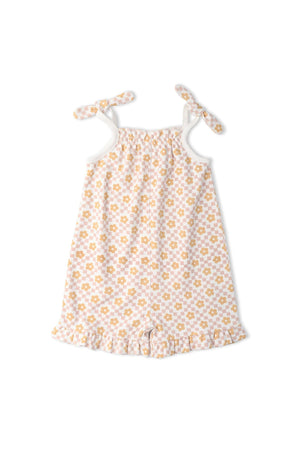 Organic Ruffle Jumpsuit in Pop Floral features a soft, lightweight fabric adorned with a cheerful floral print in yellow and white.