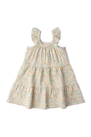 A light floral organic cotton dress featuring cascading ruffle tiers and a relaxed silhouette, perfect for children. Ideal for sunny days, it combines style and comfort in eco-friendly fabric.