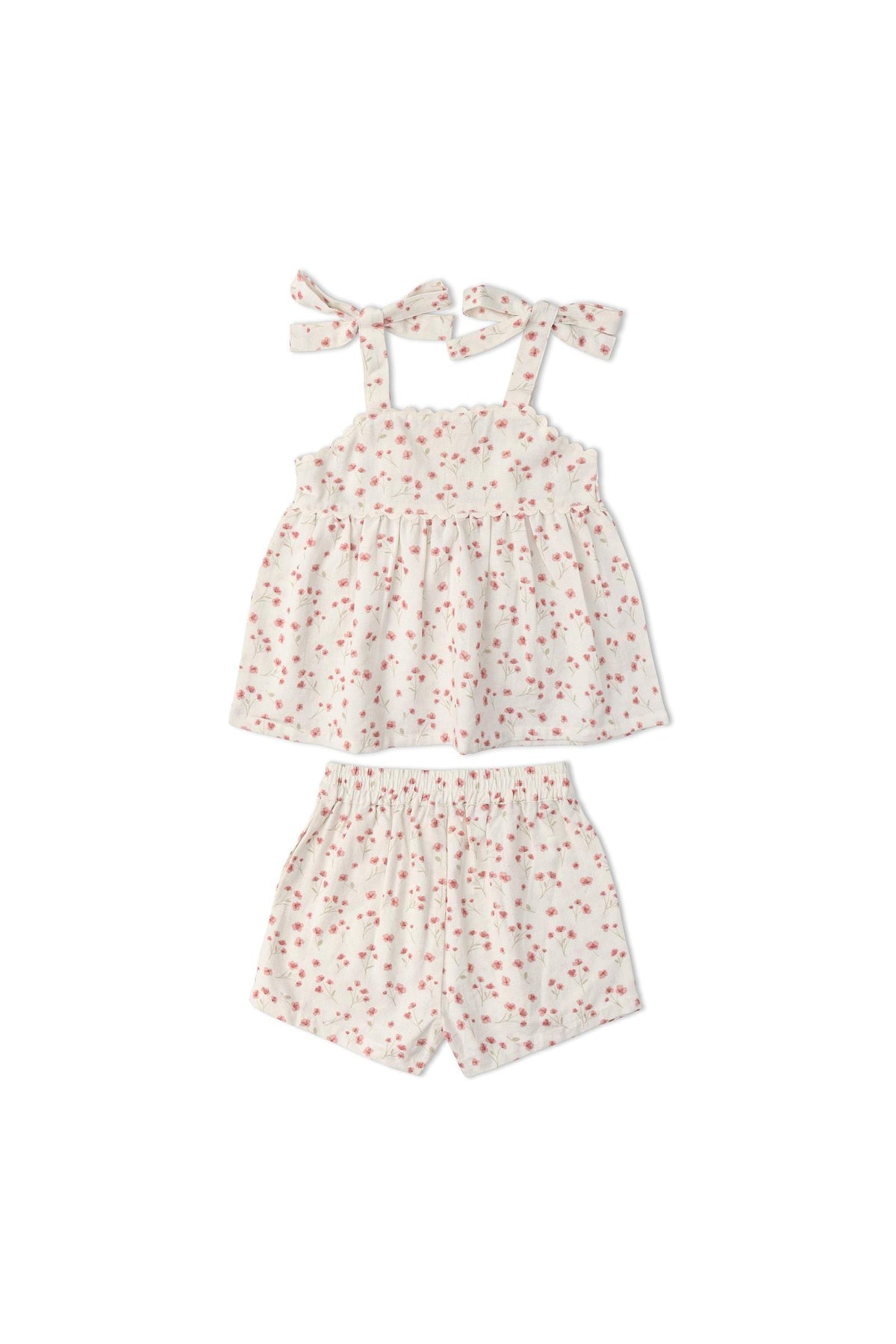 A pink floral tie-up top with adjustable straps is paired with matching shorts, all crafted from soft, organic cotton. This charming set is perfect for warm-weather outings and playful adventures.