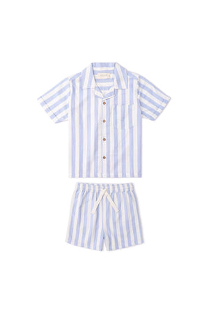A blue and white striped shirt and shorts set made from lightweight organic cotton. The short-sleeve shirt features a pocket and wooden buttons, perfect for kids summer wear.