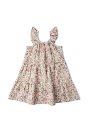 A pastel floral ruffle tiered dress featuring cascading ruffles and a relaxed silhouette. Made from organic materials, this dress is perfect for children’s playful outings and sunny days.
