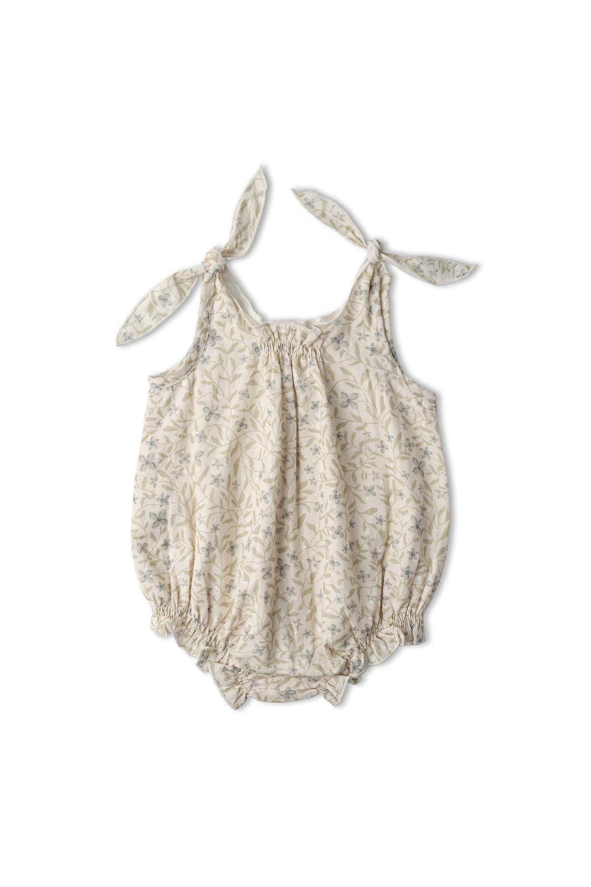 Lightly patterned organic cotton bubble romper in soft beige, featuring adjustable tie shoulder straps and elasticized leg openings, designed for comfort and playful style. Ideal for everyday wear.