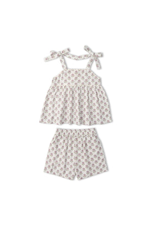 A lavender tie-up top and matching shorts set featuring a floral pattern. Made from organic cotton, this charming outfit is perfect for warm weather and playful adventures.