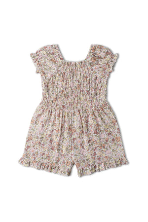 A pastel floral jumpsuit featuring a smocked bodice and frilled sleeves, made from soft organic cotton. This charming piece is perfect for comfortable, stylish wear on warm days.