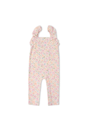 A floral-patterned organic cotton romper features delicate flutter sleeves and a relaxed fit, ideal for sunny days and designed for comfort in everyday adventures. Perfect for babies.