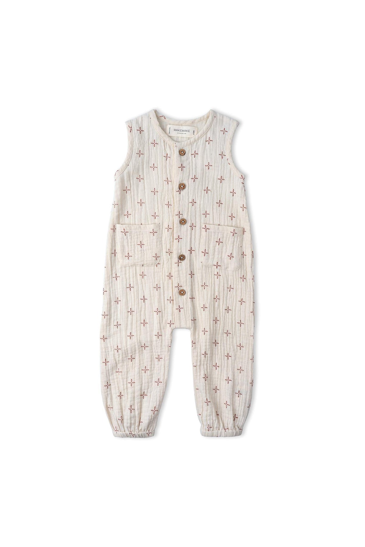 Organic Buttoned Jumpsuit by Makemake Organics features a light beige cotton fabric with a subtle cross pattern, wooden buttons, and a relaxed fit, perfect for comfortable play.