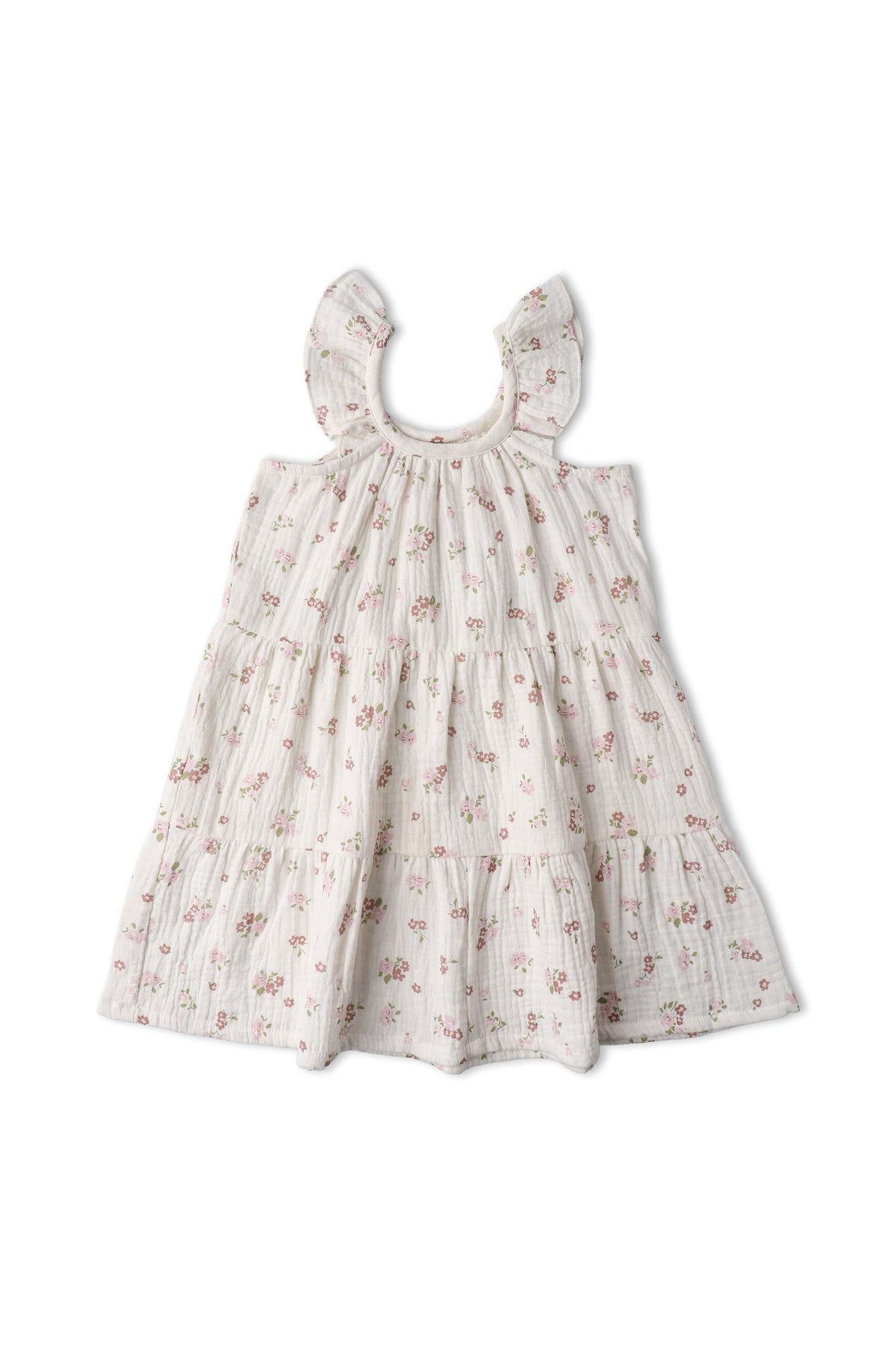 A blush floral dress made of lightweight, organic cotton features cascading ruffles along the shoulders and a tiered skirt, perfect for twirling and sunny days. Ideal for children.