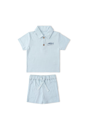 Light blue organic cotton polo shirt and matching shorts set featuring a buttoned collar and playful fish embroidery, perfect for children’s casual wear. Ideal for comfort and style during playdates.