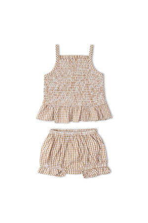 Organic caramel check smocked top and bloomer set featuring delicate smocking and a ruffled hem. Made from lightweight, breathable fabric, perfect for warm weather adventures for young children.