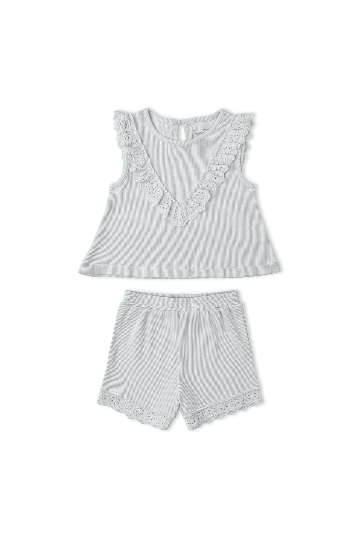 Light gray organic cotton ruffle top with a scalloped neckline paired with matching shorts featuring delicate lace trim. This charming set is perfect for young children’s warm-weather outfits.