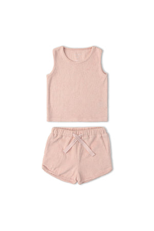 Organic cotton sleeveless tee and shorts set in soft blush, featuring a relaxed fit and towel-like texture. Ideal for comfortable, laid-back days at home or outdoors.