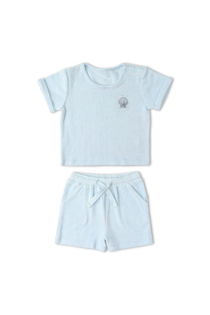 Light blue organic terry tee and shorts set featuring a soft, towel-like texture. Designed for comfort, it includes a relaxed fit, perfect for warm days and casual wear.