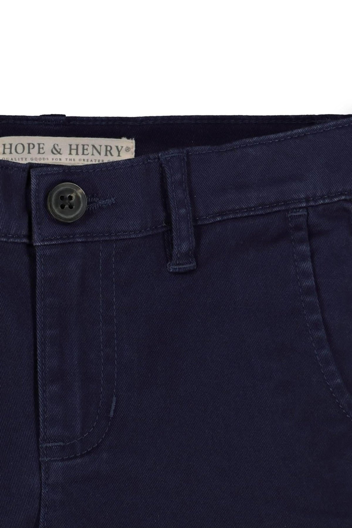 Close-up of navy blue organic cotton twill chinos from Hope & Henry, featuring a faux horn button and adjustable waistband.