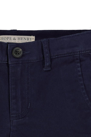 Close-up of navy blue organic cotton twill chinos from Hope & Henry, featuring a faux horn button and adjustable waistband.