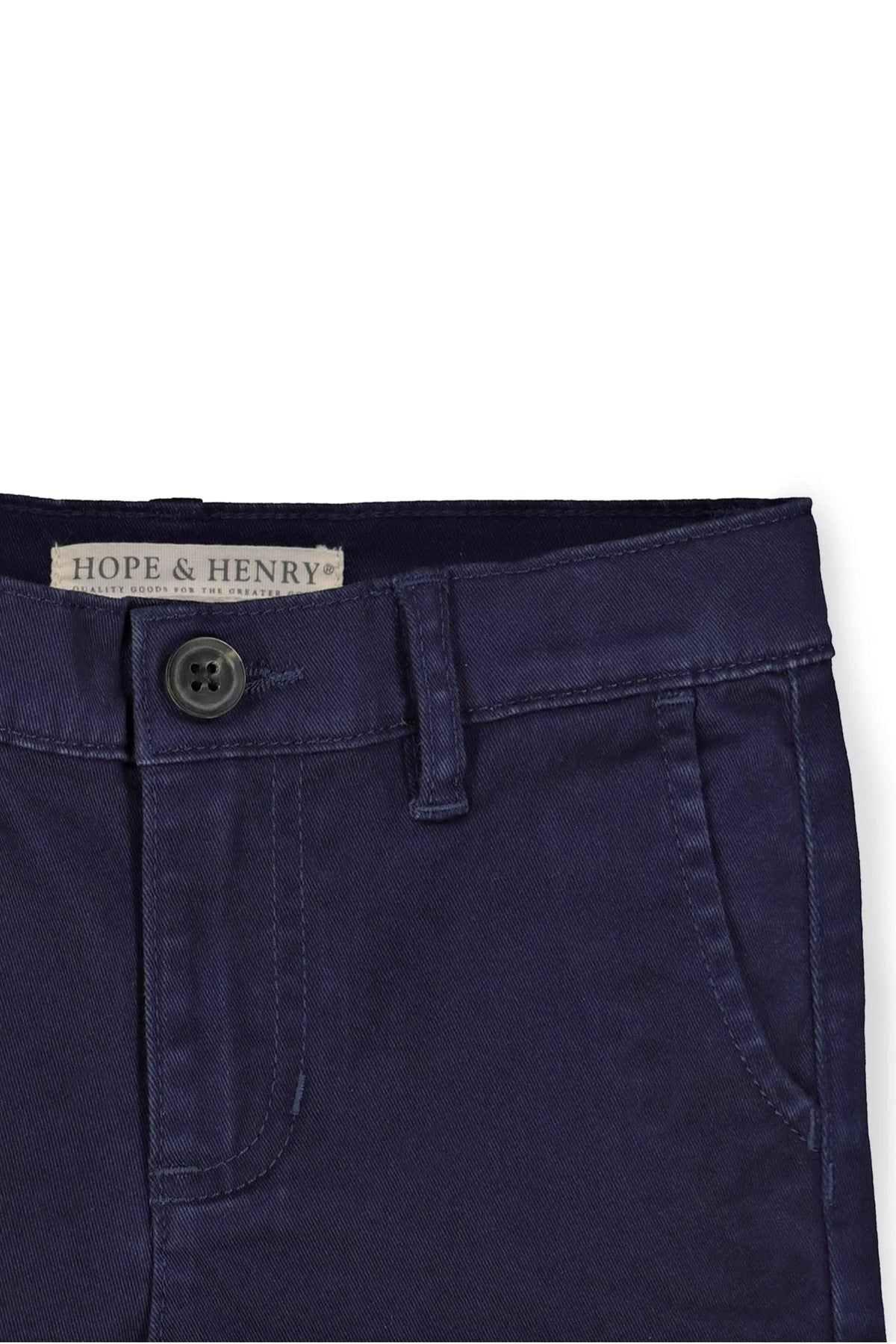 Close-up of navy organic cotton skinny chino pants featuring a button closure and front pockets, showcasing clean stitching and durable.