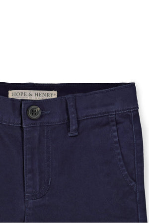 Close-up of navy organic cotton skinny chino pants featuring a button closure and front pockets, showcasing clean stitching and durable.