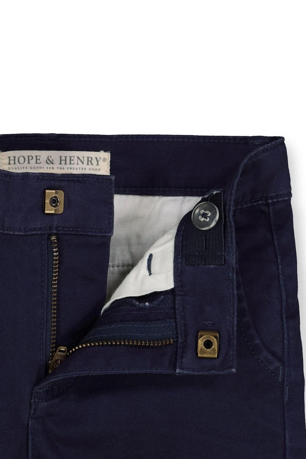 Close-up of navy organic cotton chino pants by Hope & Henry, showcasing the zipper, button closure, and inner lining details.