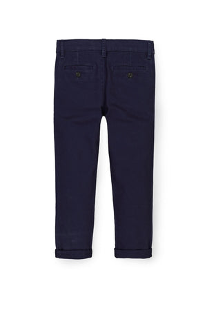 Navy blue skinny chinos made from organic cotton twill, featuring faux horn buttons and an adjustable waistband for a comfortable.
