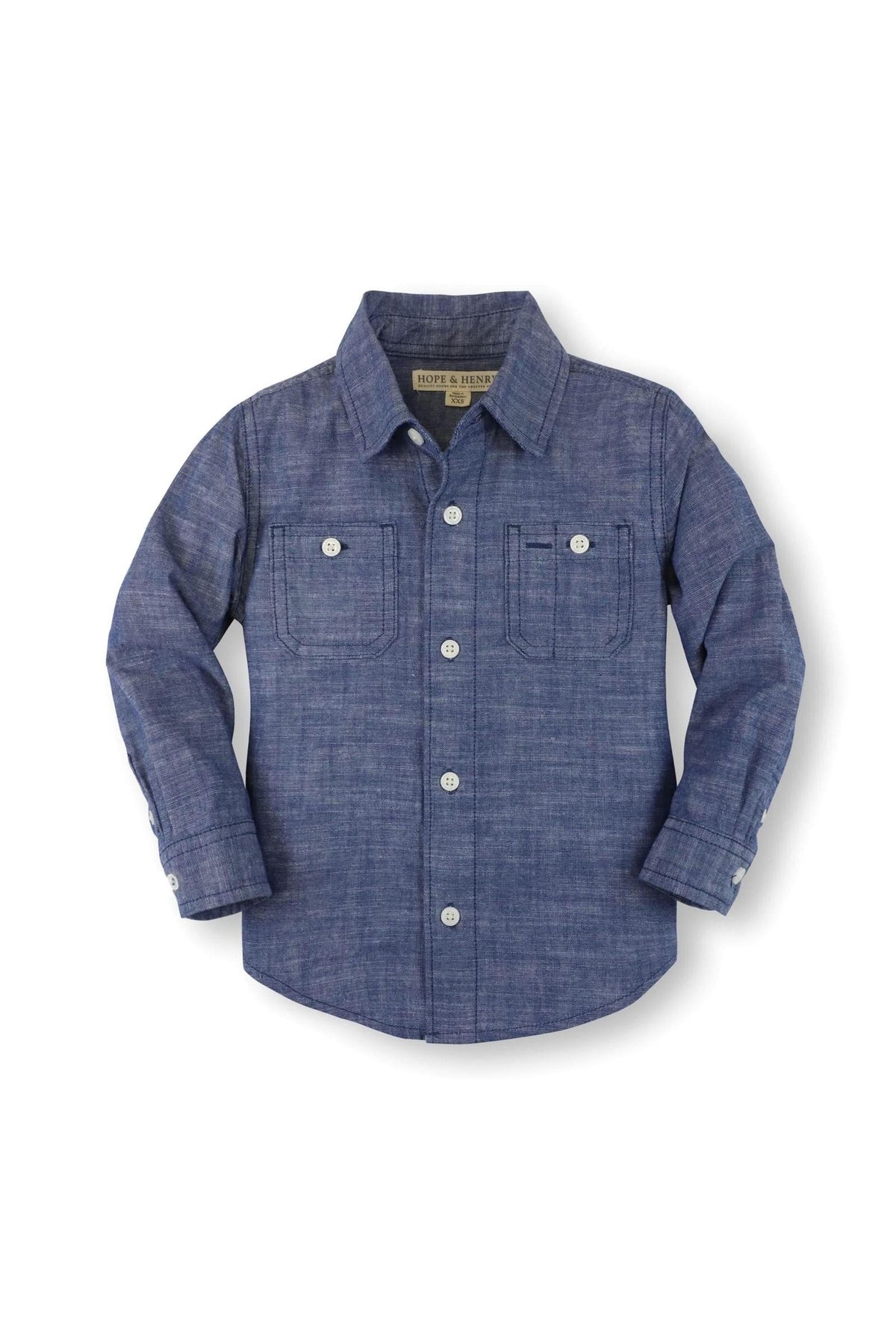 A blue organic cotton button-down shirt for boys features matte buttons, chest pockets, and long sleeves. Ideal for casual wear.